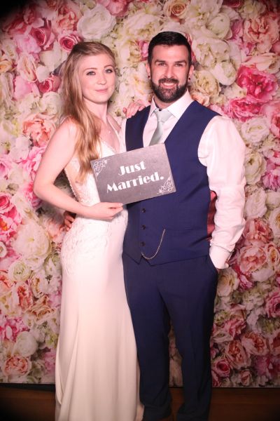 The happy couple with a just married board